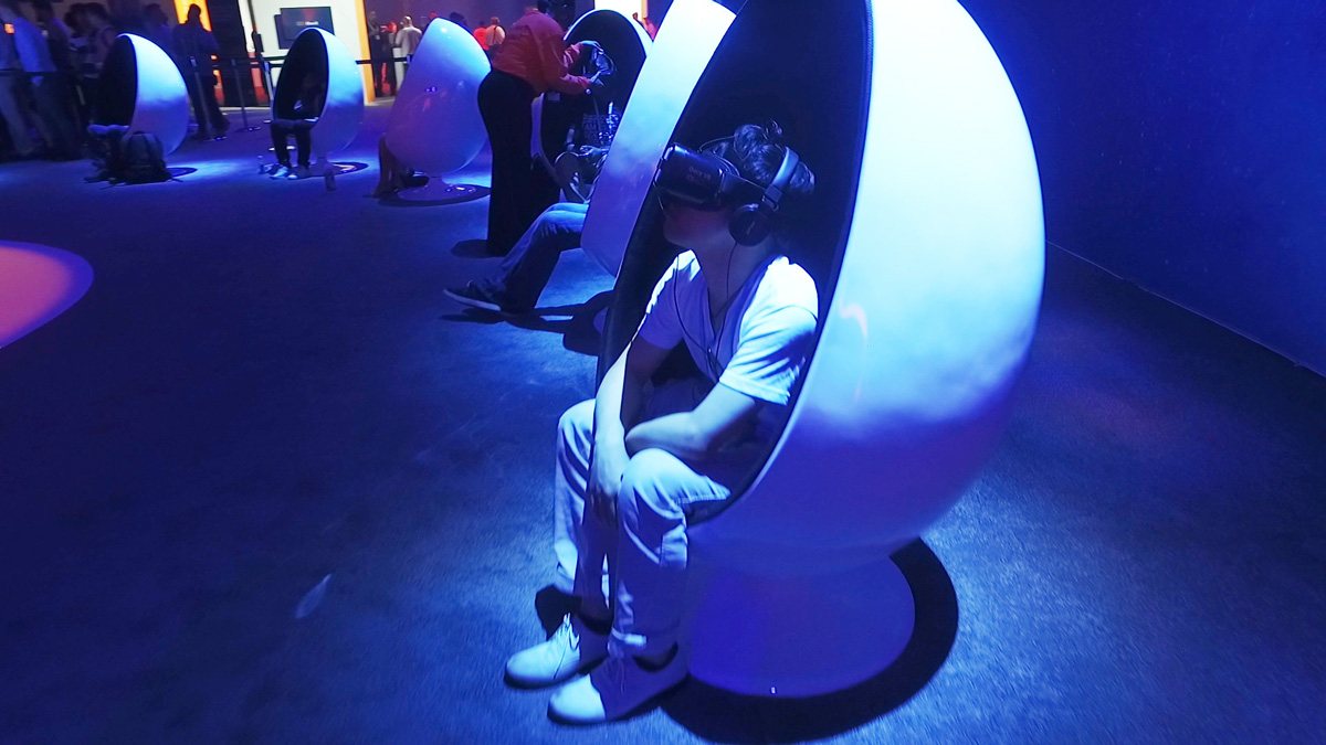Close-up of a guest wearing a VR headset inside an egg chair