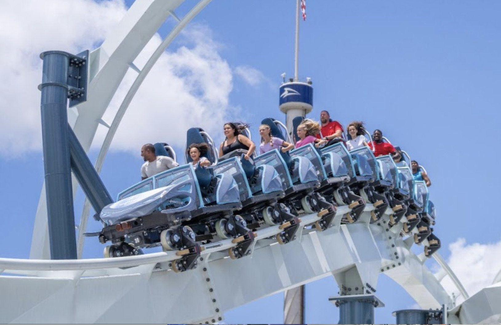 Penguin Trek coaster train launching past themed Antarctic ice caves