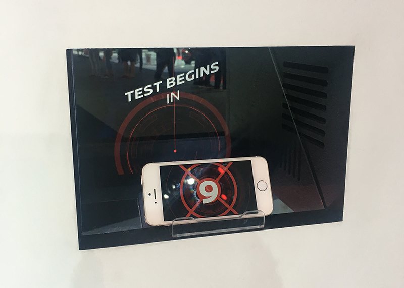 Phone in the kiosk cradle showing the Test Begins In countdown